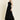 Woman wearing a black dress on a beige background
