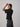 a model wearing a striped ribbed short sleeve shirt on a grey background