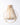 A cream colored backpack on a white background. 