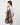 A model wearing a multi color shoulder bag on a white background. 