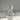 clear glass carafe with a cup etched with floral patterns on a white tile background