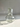 clear glass carafe with a cup etched with floral patterns on a white tile background