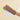 A striped fabric oven mitt worn on a person's hand, featuring alternating stripes of orange, teal green, light blue, and olive yellow, set against a plain beige background.