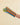 A striped fabric oven mitt worn on a person's hand, featuring alternating stripes of orange, teal green, light blue, and olive yellow, set against a plain beige background.