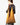 A model wearing a golden colored purse on a grey background. 
