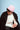 Person wearing a pink beanie and white sweater against a light blue background