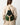 A model wearing a multi color green and cream backpack on a white background.
