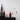 Decorative vase with geometric shapes on a black surface against a white wall