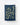 Navy blue towel with gold botanical pattern hanging on a line against a white background