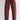 Red pants worn by a person on a white background