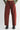 Red pants worn by a person on a white background
