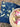 Napkin with floral pattern next to a bowl of food on grass