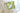 Green patterned fabric with a tag on a white surface