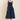 Woman wearing a navy blue dress on a beige background