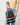 Person holding a pleated tote bag with red and black stripes on a plain background