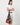 A model wearing a multi color shoulder bag on a white background. 