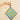 Hand holding a striped pouch with blue and green stripes on a beige background