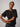 a model wearing a striped ribbed short sleeve shirt on a grey background