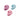 Three pink and blue skull-shaped candies on a white background