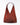 A red shoulder bag on a grey background. 