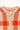 A close up cream and red-orange plaid knit sweater on a white background.