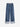 A pair of striped denim jeans on a white background. 