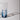 A blue and white glass carafe on a light gray background