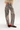 A person wearing wide-leg gray pants with a white spotted animal print, paired with a cream fringed top and brown shoes, shown from the waist down on a white studio background.