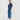 Woman wearing a blue top and denim skirt on a white background