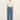 A model wearing a white shirt and lace patterned jeans on a white background. 