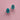 A pair of sterling silver and turquoise earrings featuring a butterfly and a sprig of eucalyptus on a pink background. 
