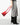 A model holding a red purse on a grey background. 