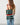 Person holding a striped bag with a plain background