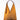 A golden colored purse on a grey background. 