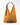 A golden colored purse on a grey background. 