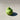 green pear shaped candle on a light grey surface