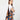 A model wearing a multi color shoulder bag on a white background. 