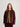 Person wearing a maroon and yellow jacket on a plain background