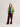 Person wearing a mustard yellow jacket with green accents on a plain background