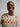 A model wearing a colorful sweater and on a white background. 