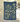 Navy blue towel with gold floral pattern against a textured wall background