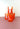 bright orange striped tumblers on a pink surface with a white background