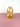 A pink and yellow glass vase on a pink surface and white background