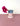 a pink and blue vase with flower on a pink surface with a white background
