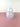 A translucent white vase on a pink surface on a white background