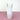 a white glass vase on a pink surface with a white background